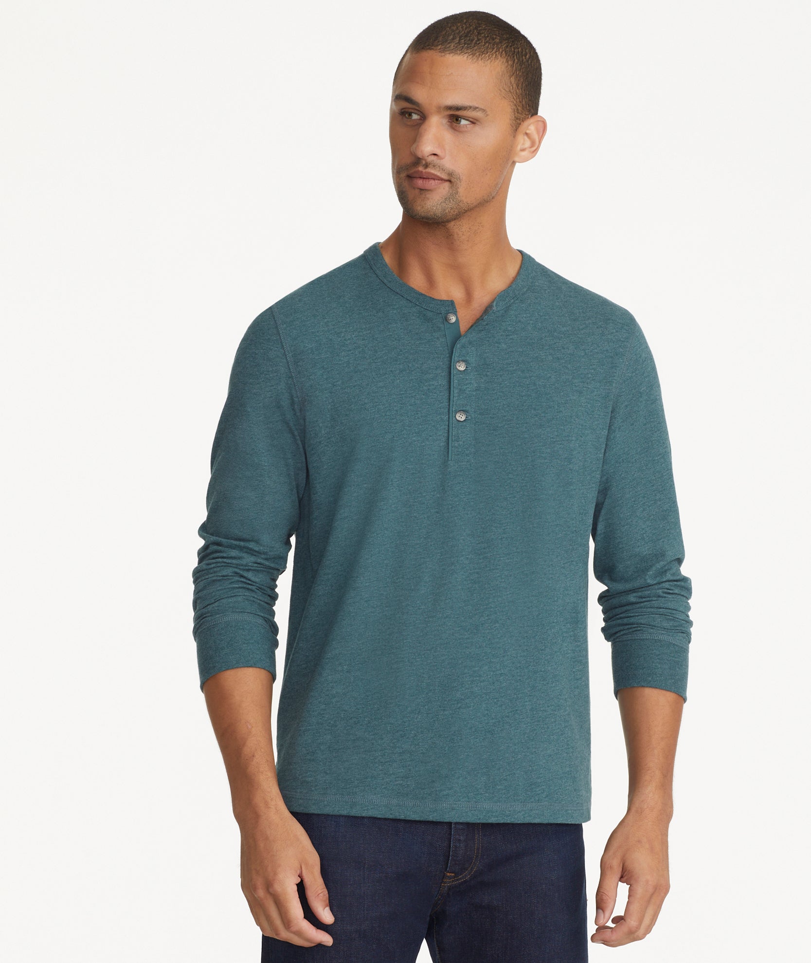 Model is wearing UNTUCKit ultra soft henley Albarino in Balsam.