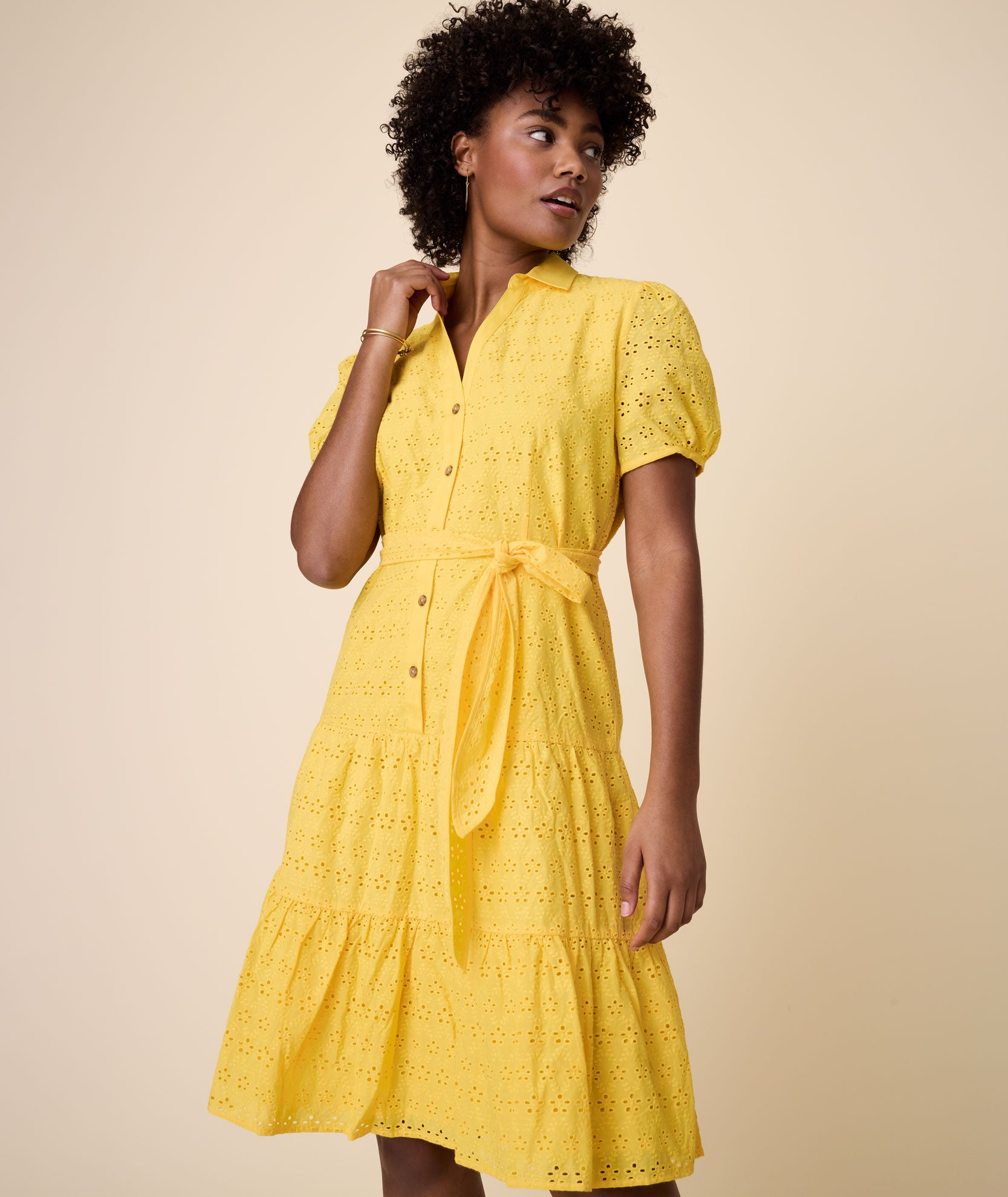 Model is wearing UNTUCKit solid Yellow Augusta Dress.