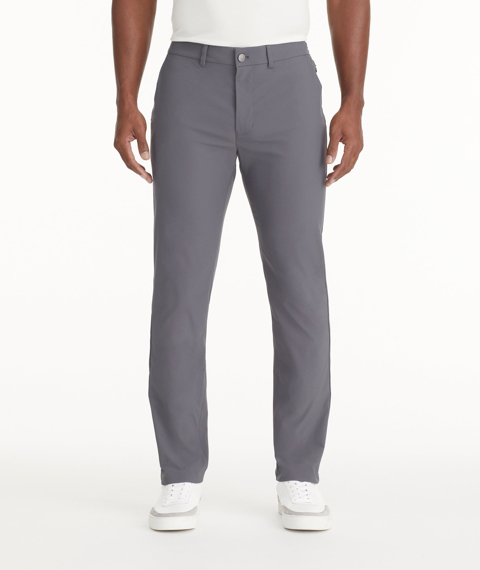 Model is wearing UNTUCKit Traveler Tech Pants in gray. 