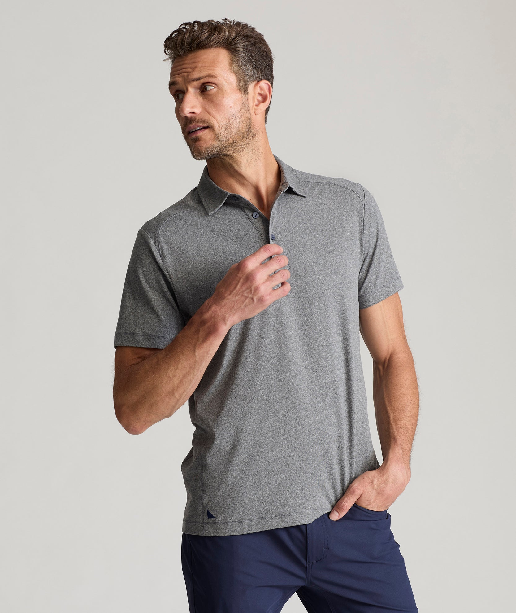 Model is wearing UNTUCKit Clavidor polo in gray. 