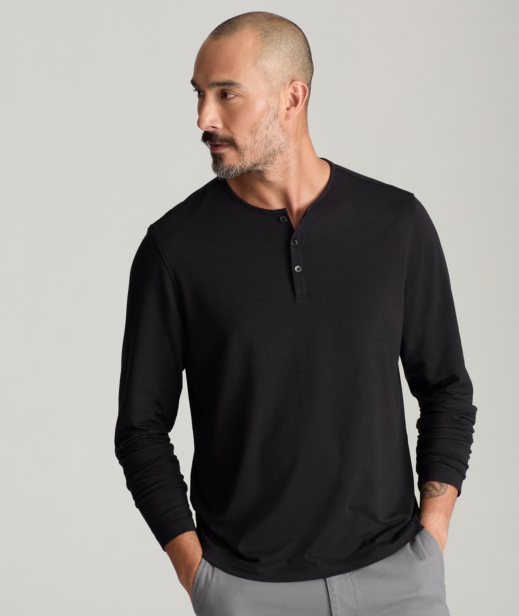 Model is wearing UNTUCKit Marastina henley in black.