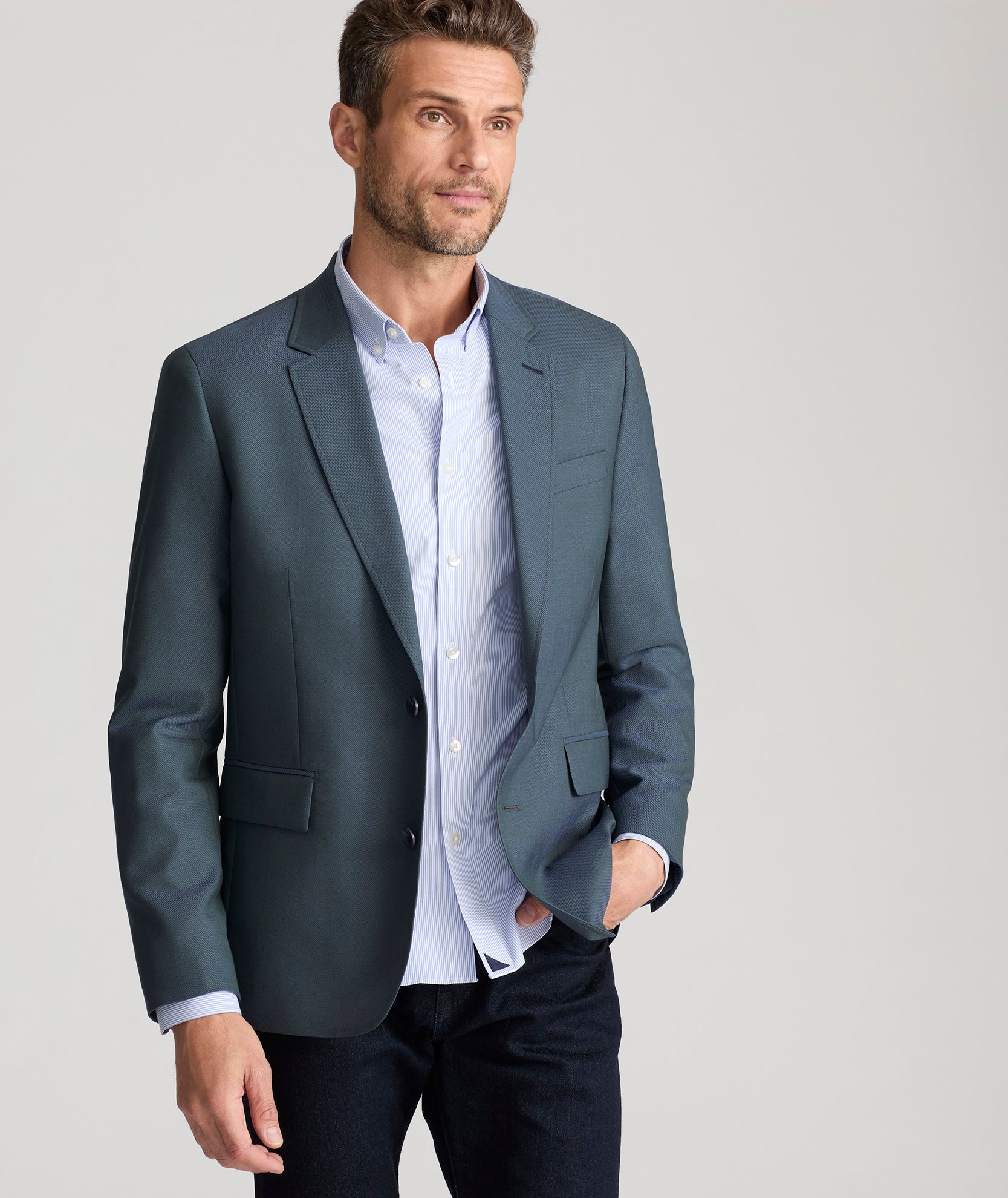 Model is wearing UNTUCKit Palazzo sport coat in teal. 