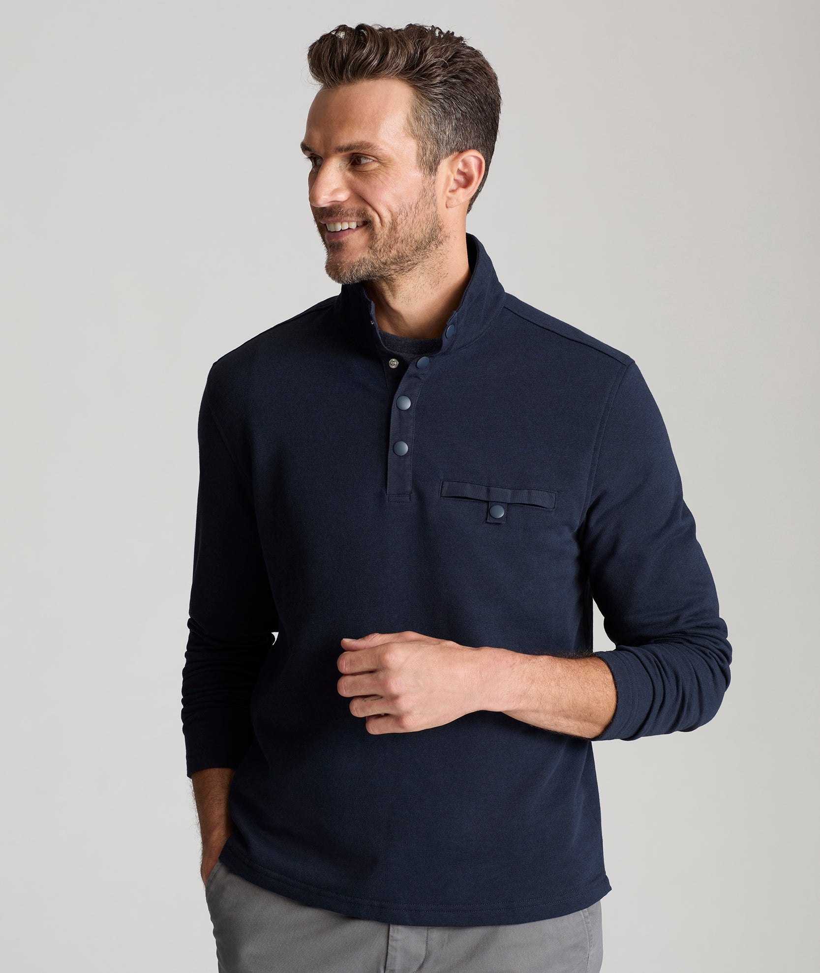 Model is wearing UNTUCKit Parkson quarter-zip sweatshirt in navy.