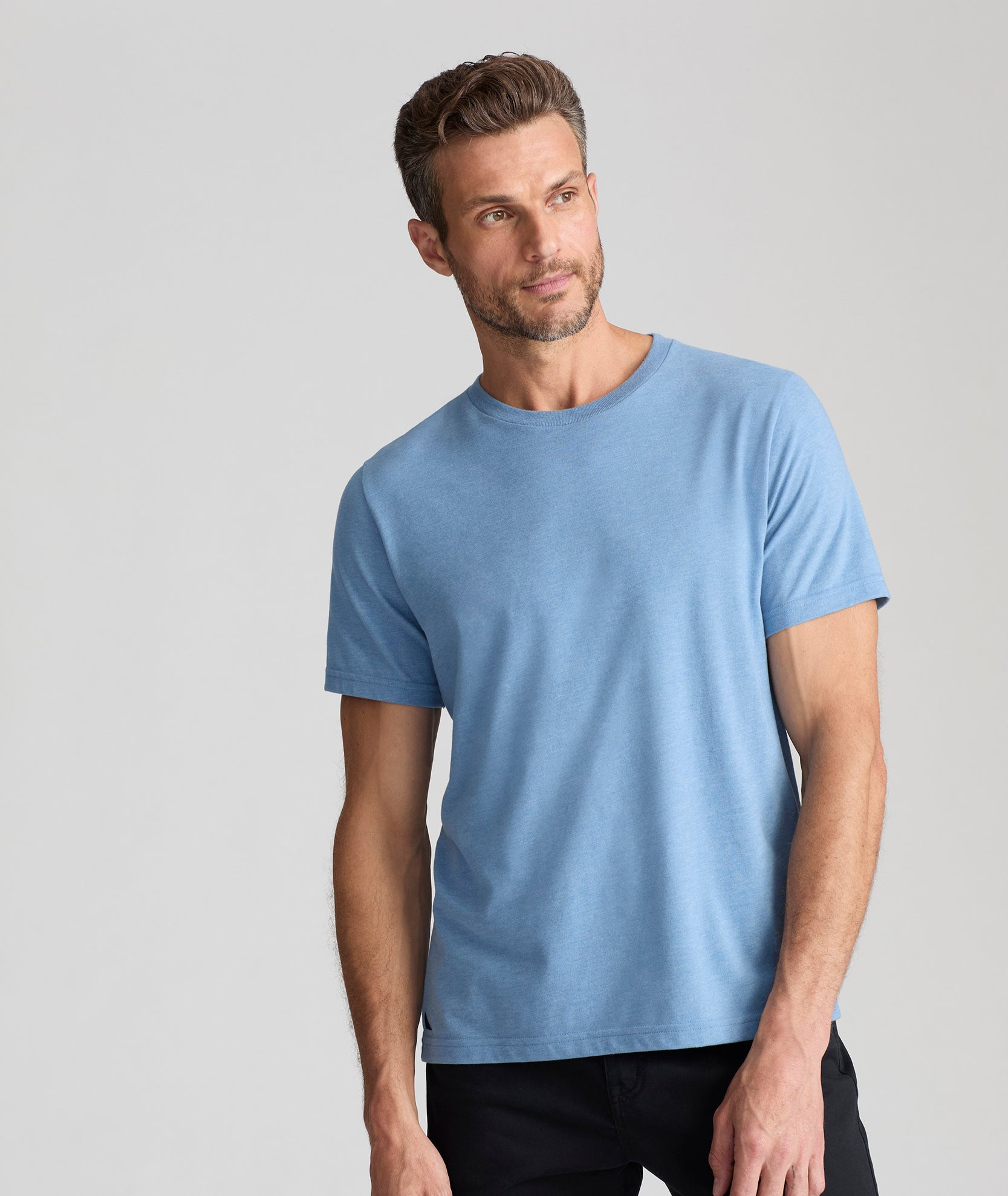 Model is wearing UNTUCKit saxum Ultra Soft tee in soft blue. 