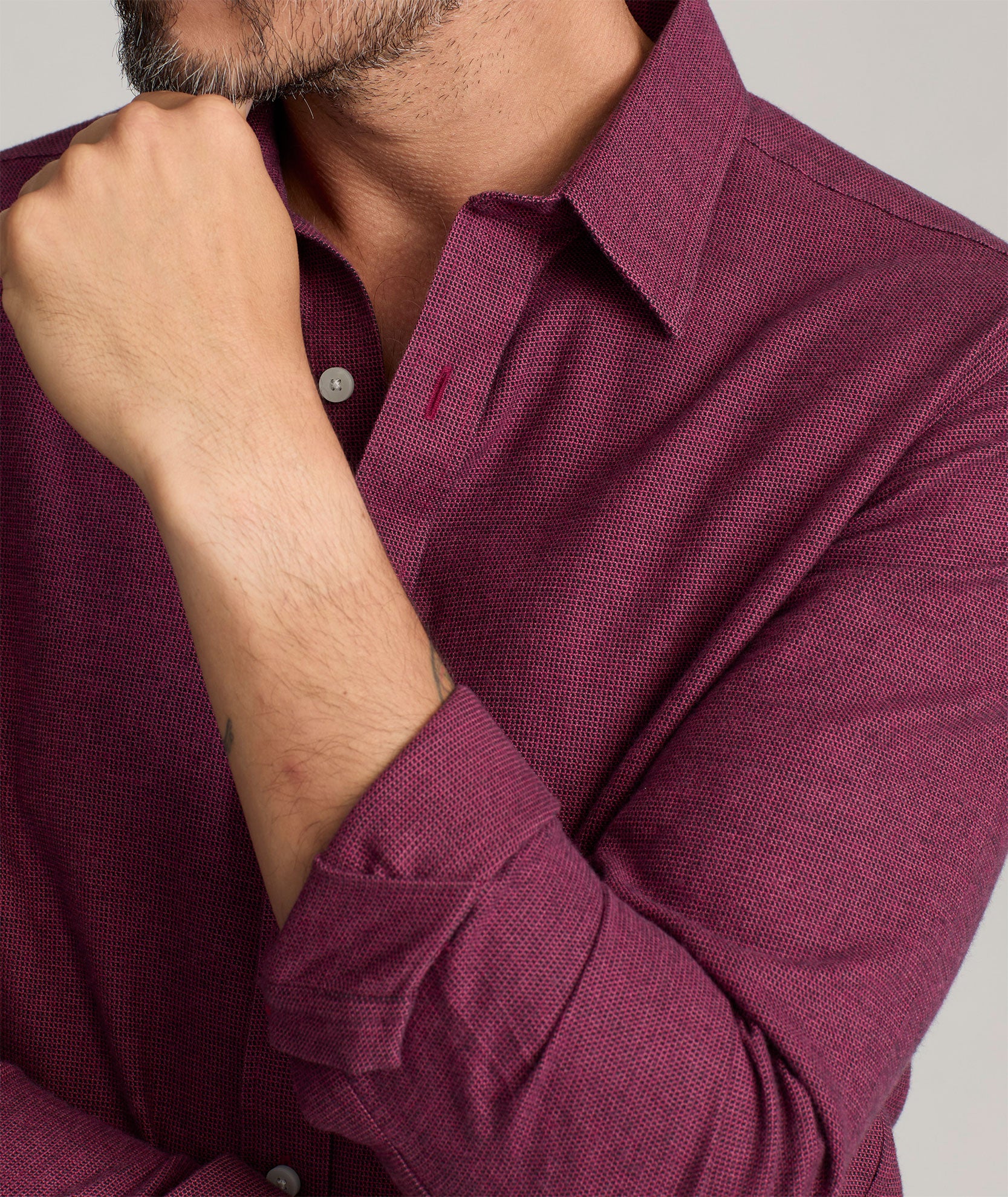 Model is wearing UNTUCKIt Wrinkle-Free Veneto Shirt in dark berry.