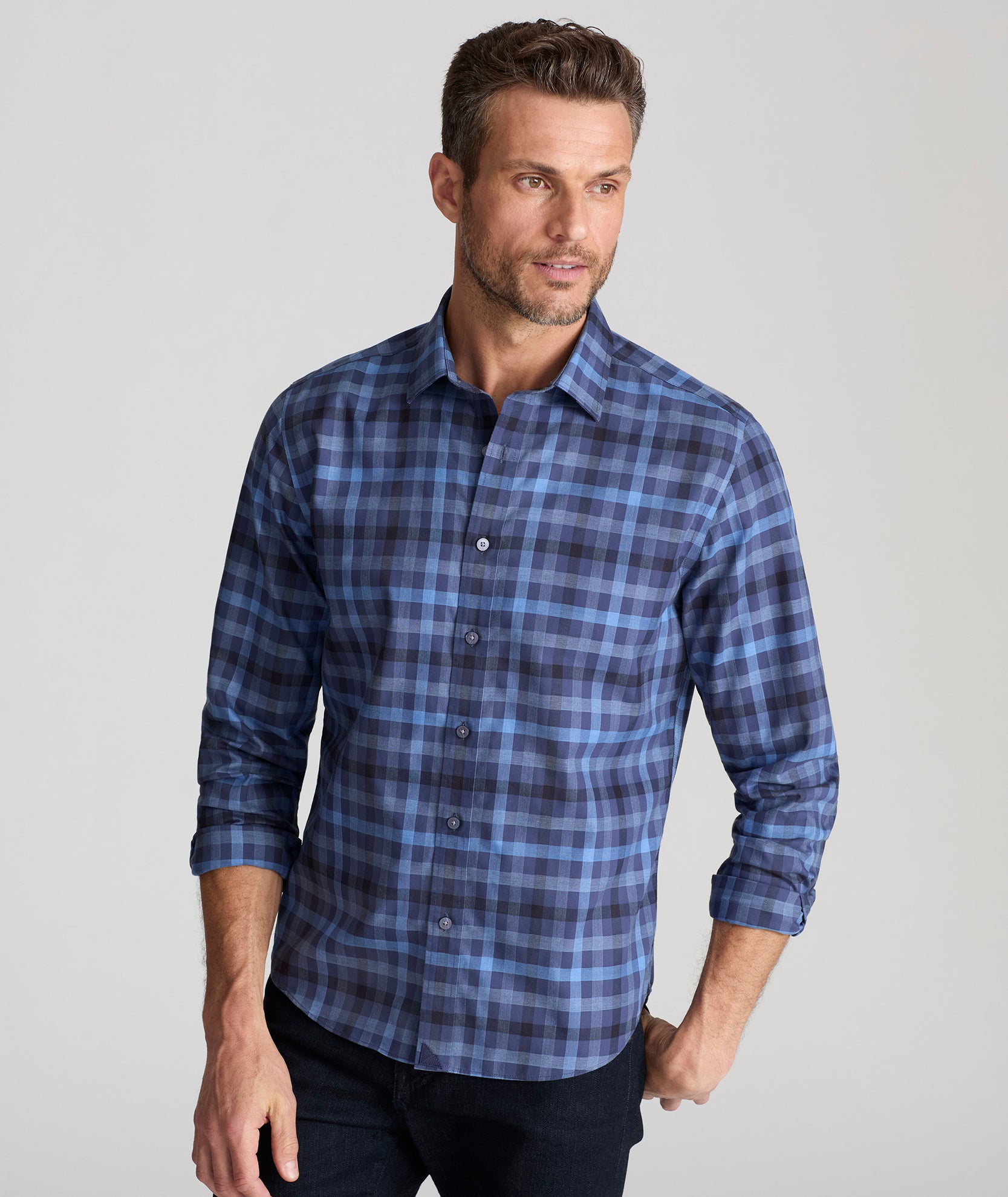 Model is wearing UNTUCKit Wrinkle-Free Walton Shirt in Blue & Black Check.