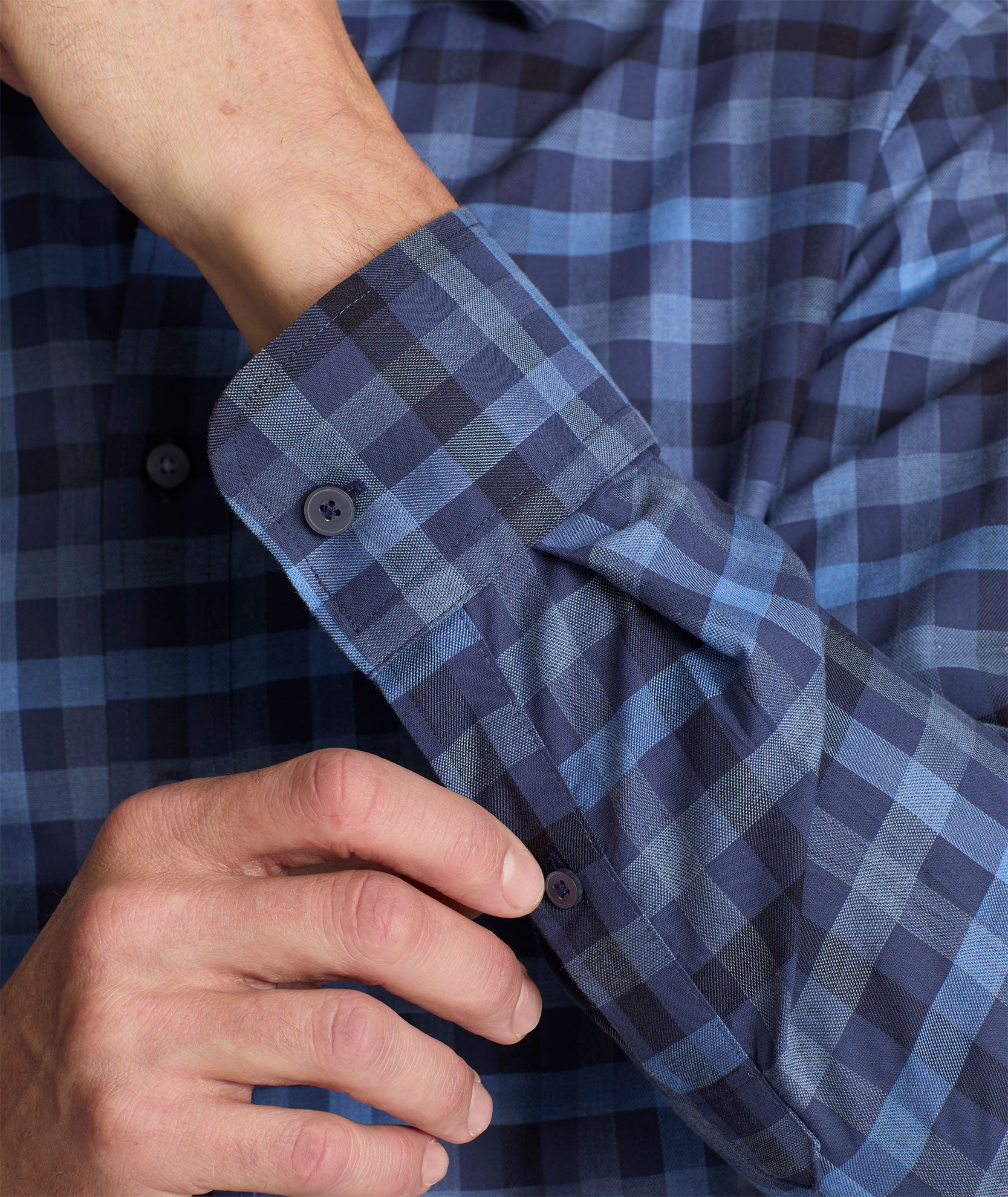 Model is wearing UNTUCKit Wrinkle-Free Walton Shirt in Blue & Black Check.