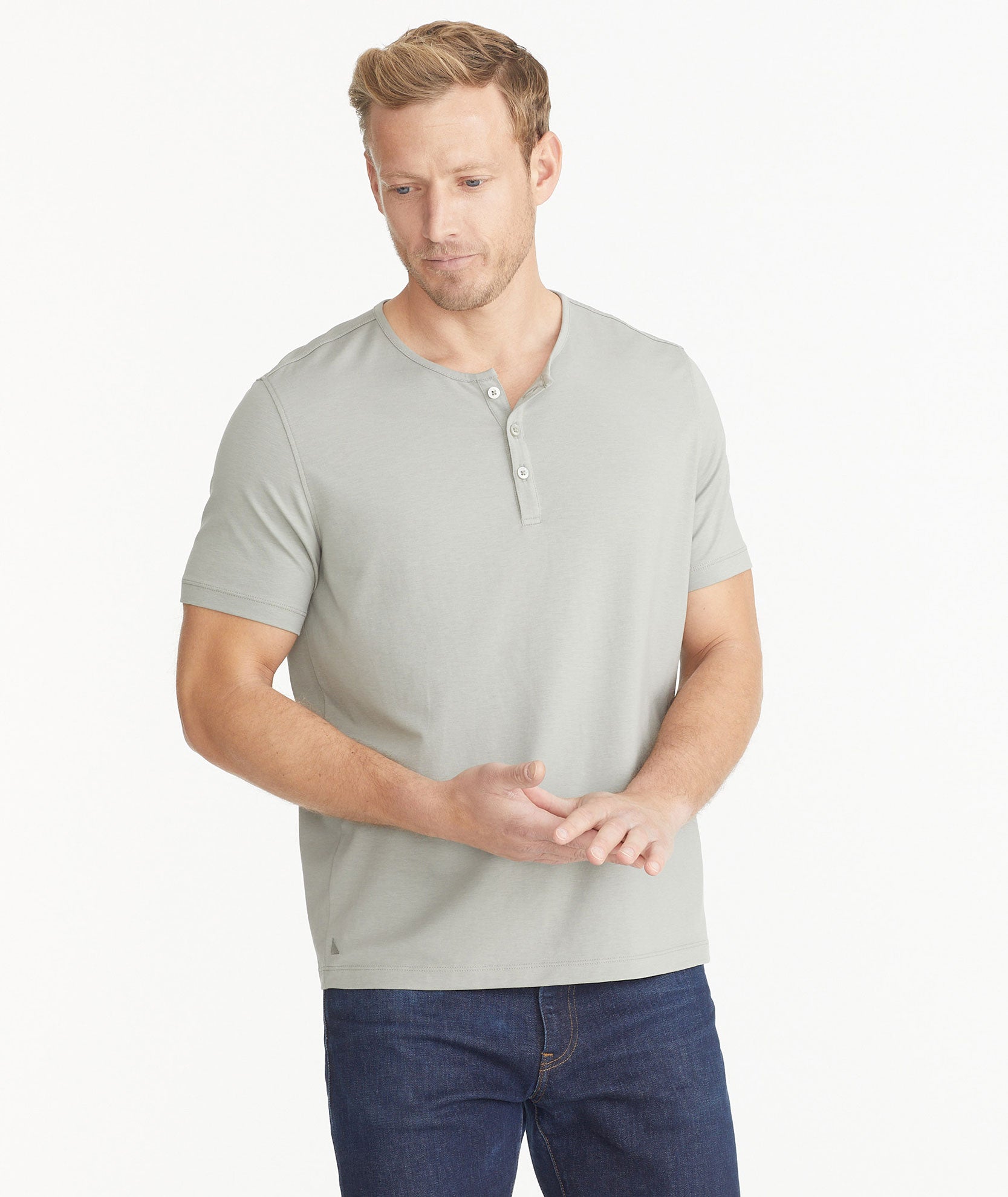 Model wearing an UNTUCKit Military Green Essential Henley in EcoSoft™.