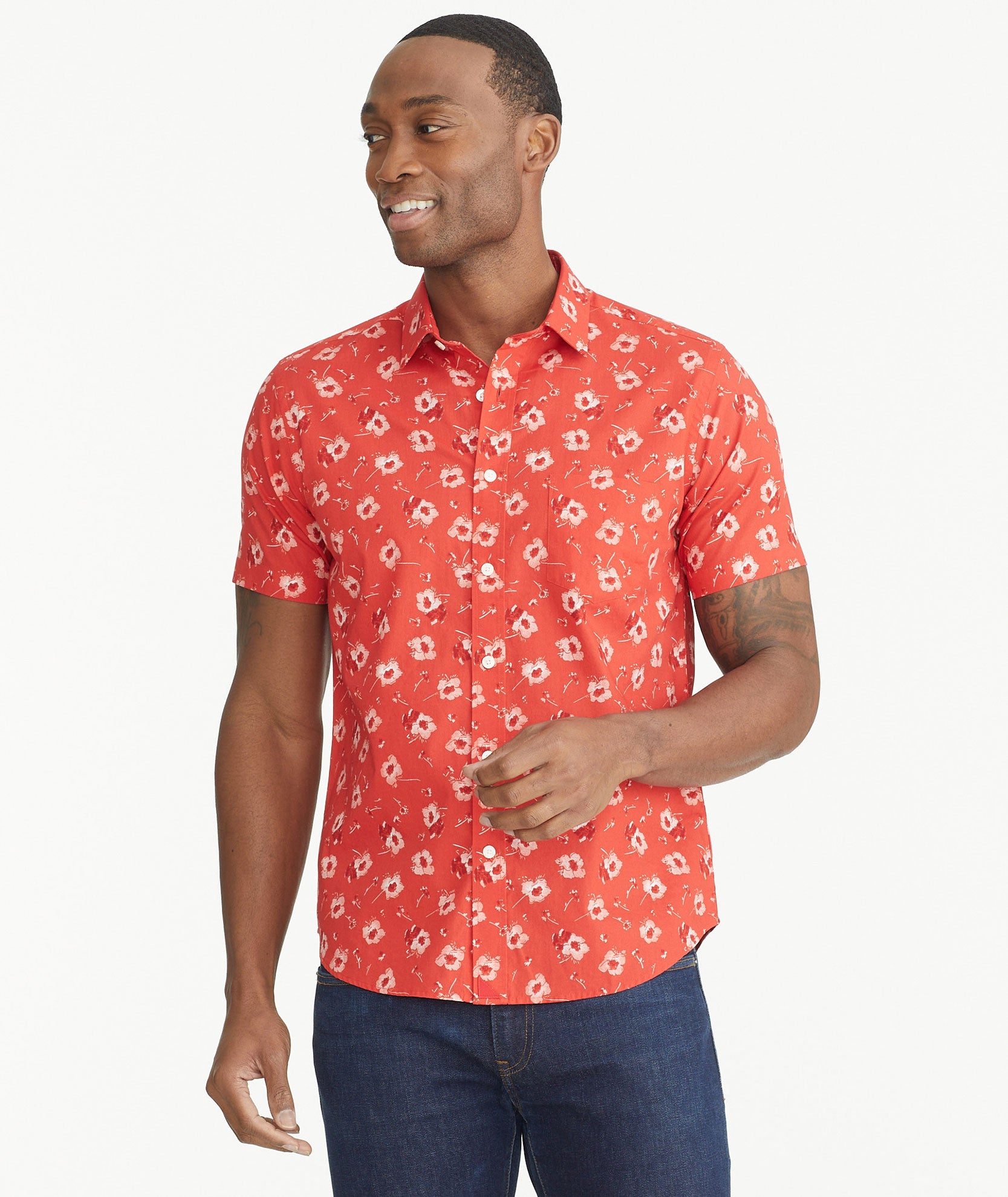 Model is wearing UNTUCKit Poppy Red Print Cotton Short-Sleeve Coolidge Shirt.