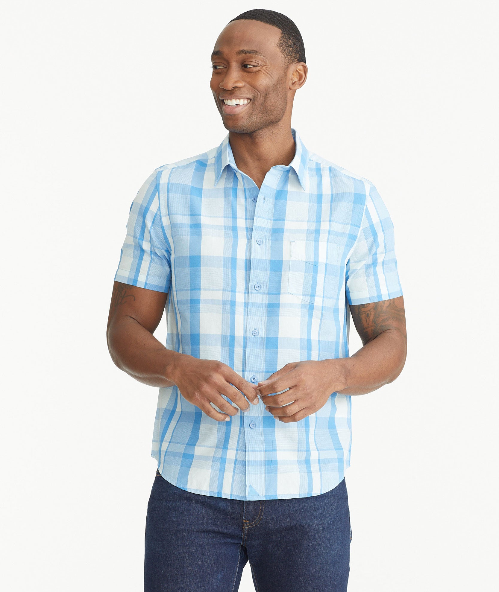 Model is wearing UNTUCKit Blue Cotton Short-Sleeve Plaid Shirt.